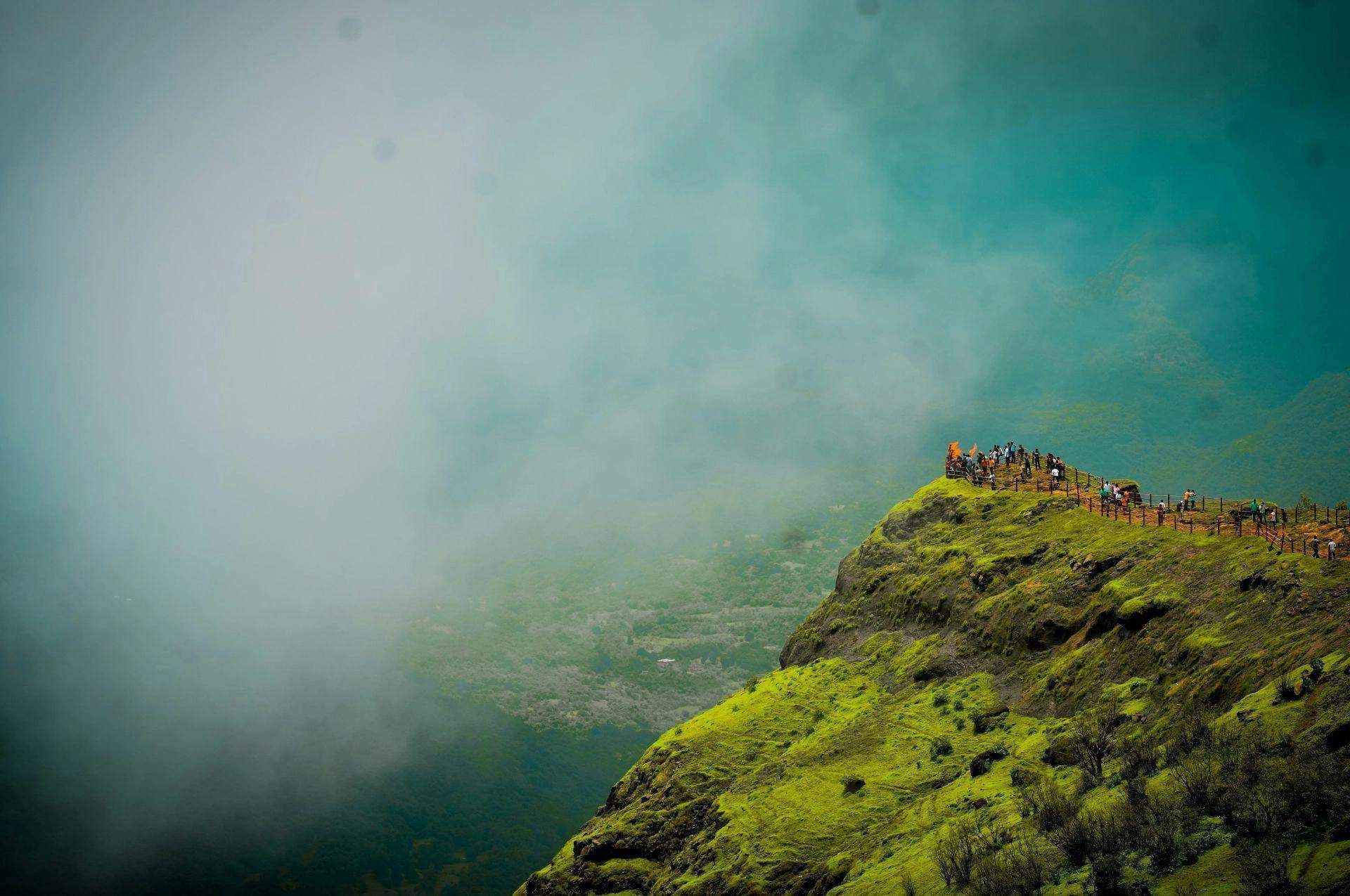 View from Ramsukh Resort overlooking mist-covered mountains and lush green landscapes in Mahabaleshwar.